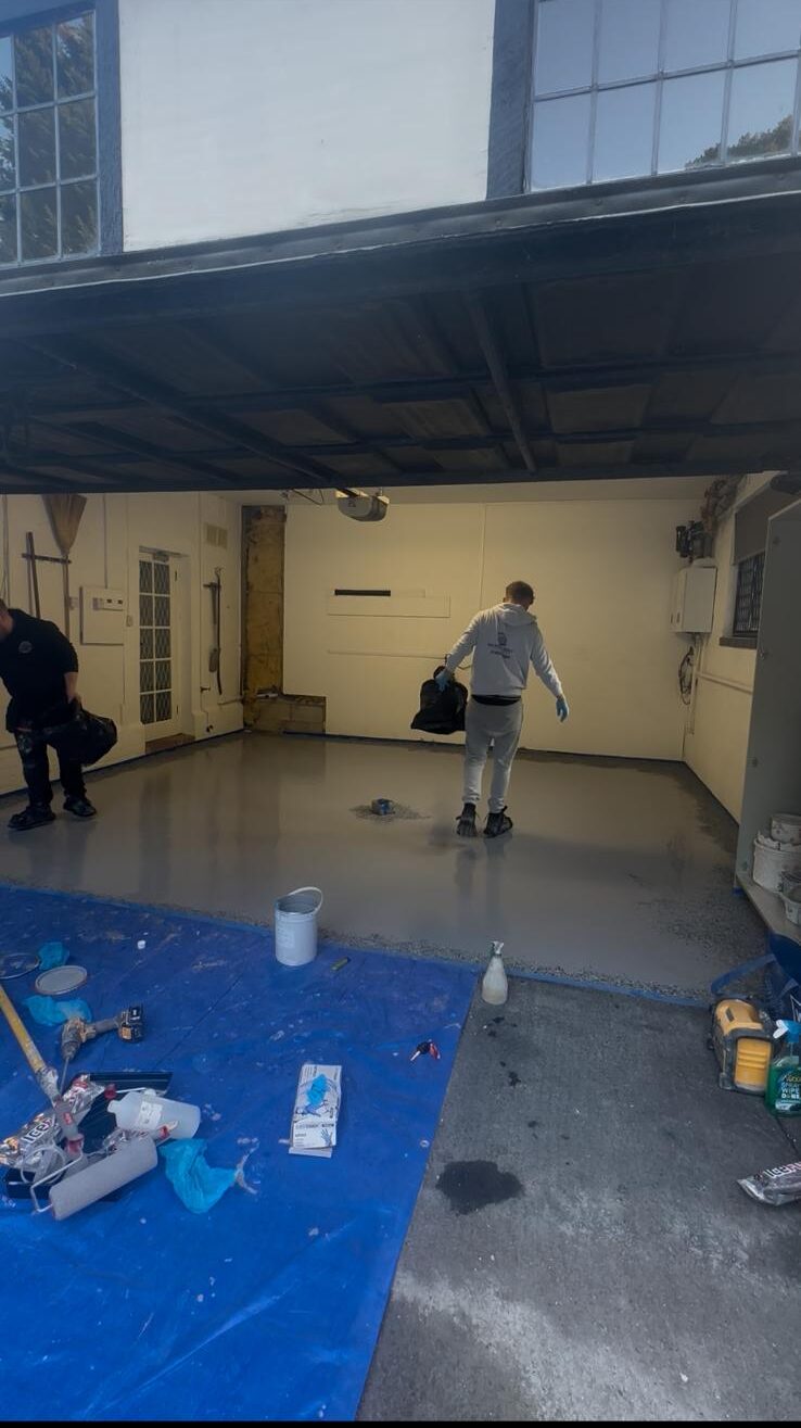 Flake being broadcast over the freshly coated garage floor