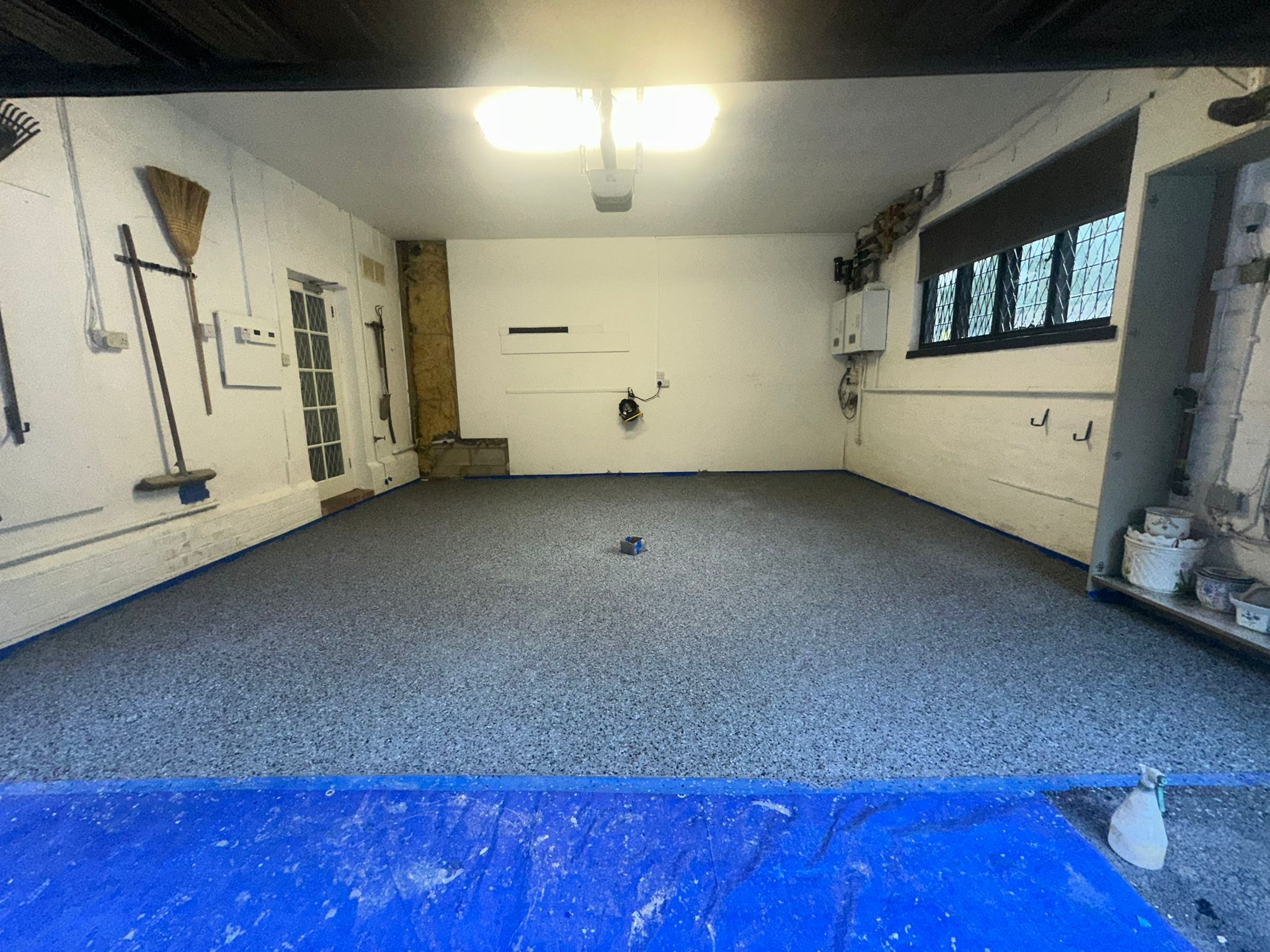 Finished grey flake resin floor in a working garage