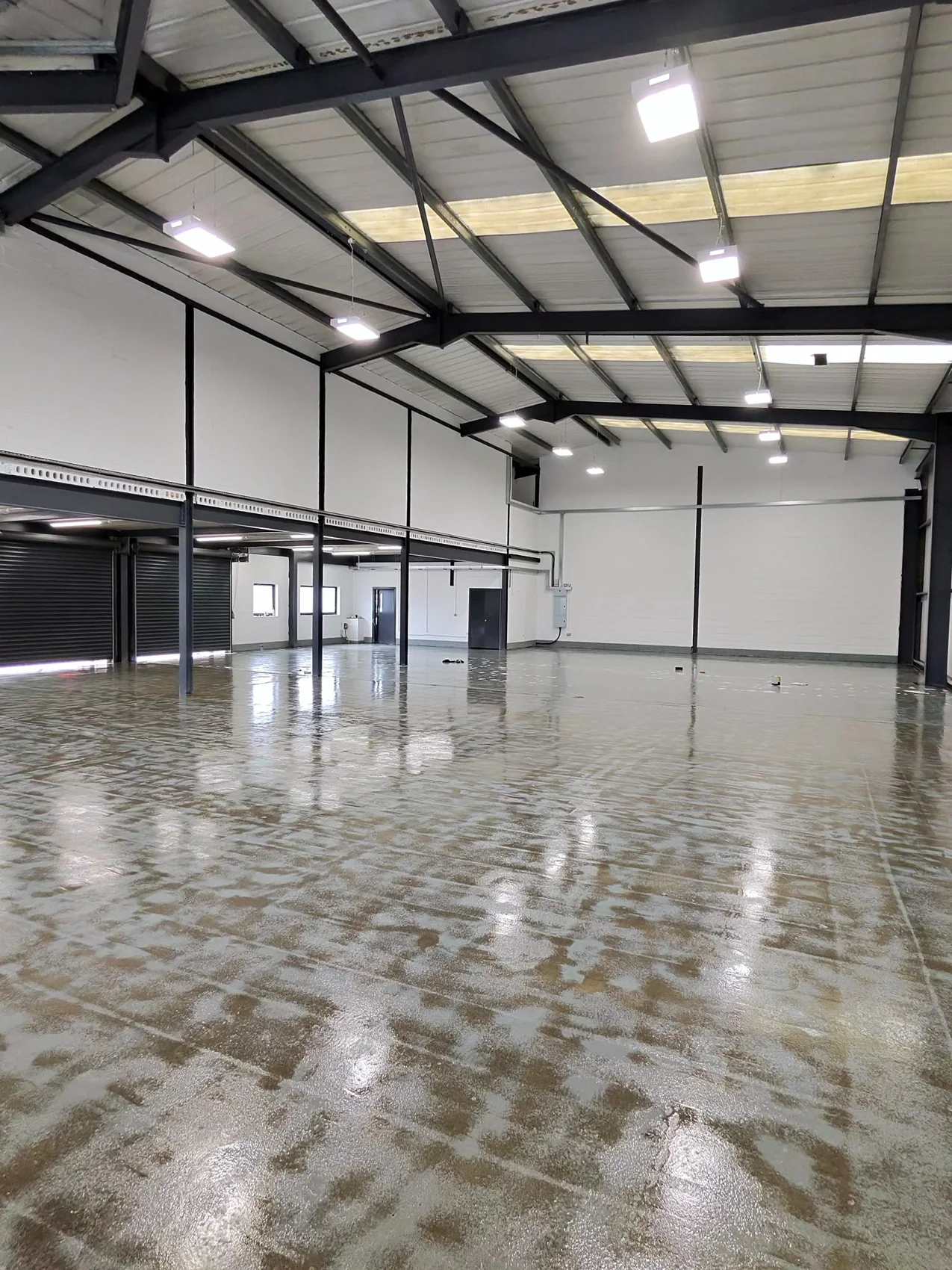 Floor coating being applied in the same warehouse