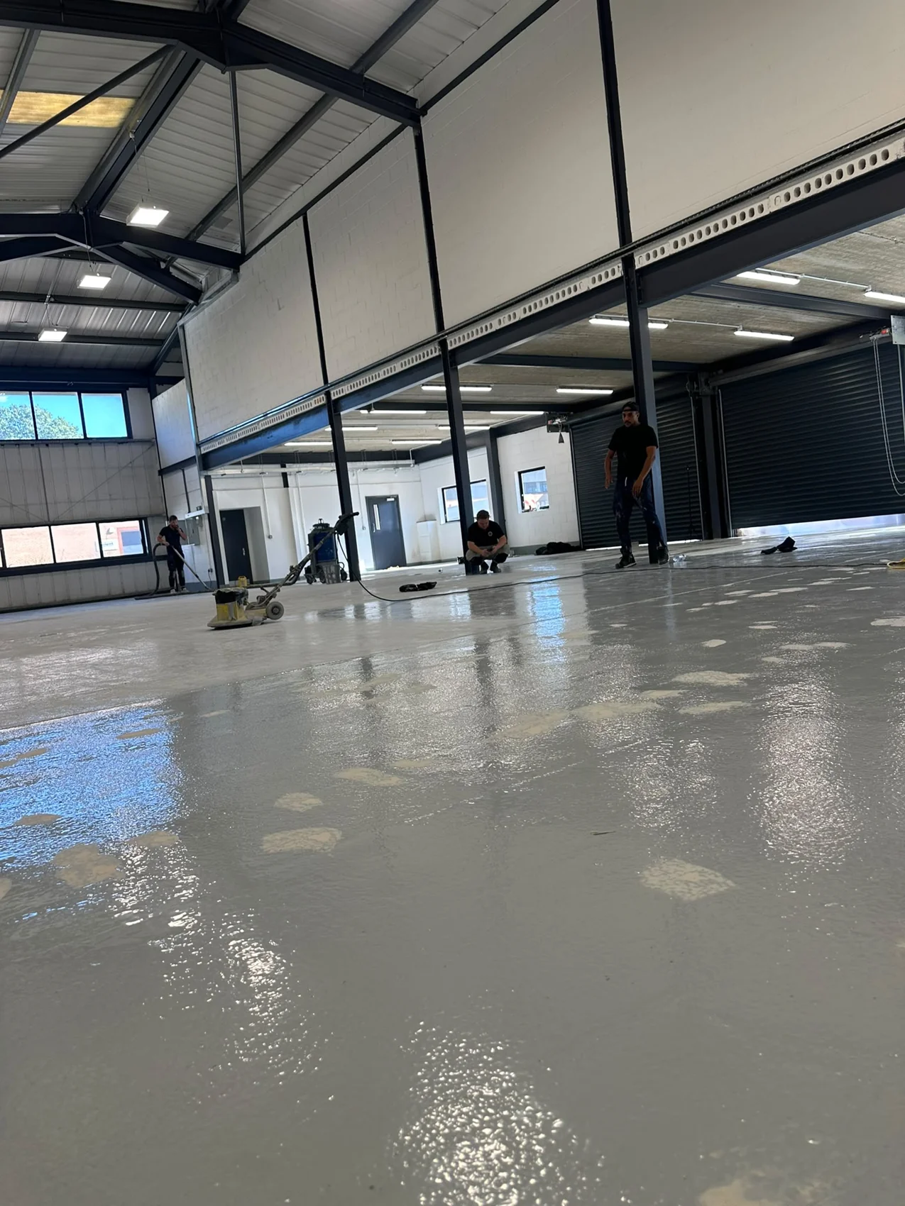 Daylight reflected across the grey warehouse floor during the job